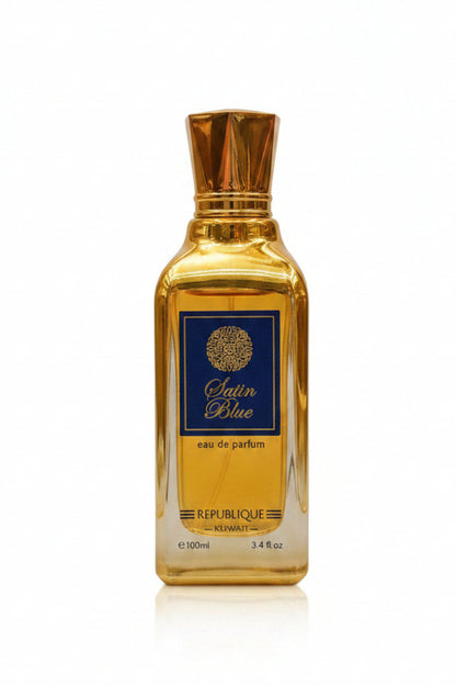 A perfume bottle and box for 'Satin Blue' with a gold and navy color scheme.